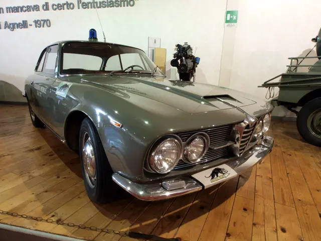 The image shows an Alfa Romeo Giulietta Sprint GTV 2000, a police car, on the floor with a chain...