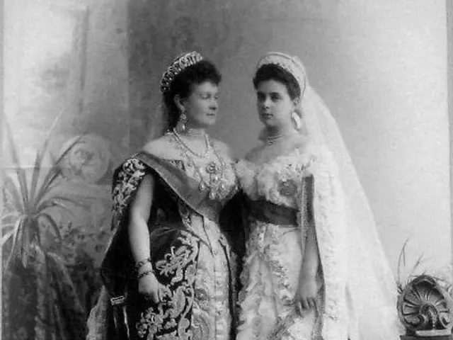 The image shows an old black and white photo of two women in wedding dresses standing side by side....