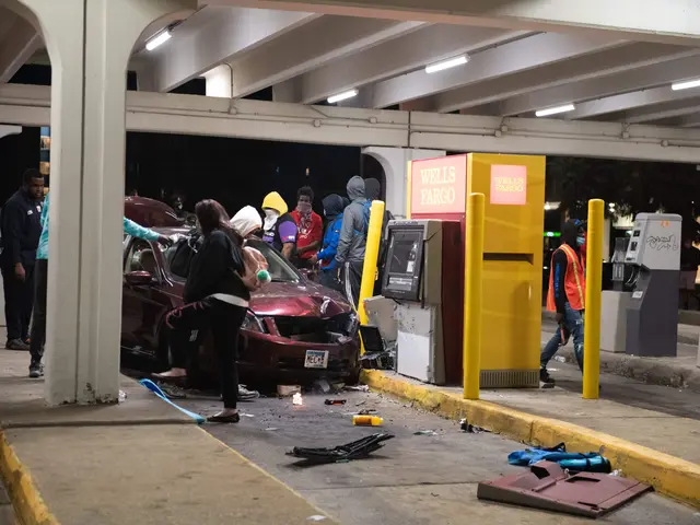 The image shows a group of people standing around a car that has crashed into a gas station. The...