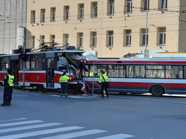 The image shows a red and white tram that has been involved in a crash on the side of the road....