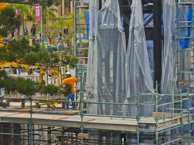 The image shows a construction site with scaffolding and scaffoldings on the side of a building....