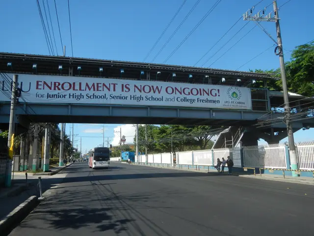 The image shows a bus driving under a bridge with a sign that reads "Enrollment is Now Ongoing" on...