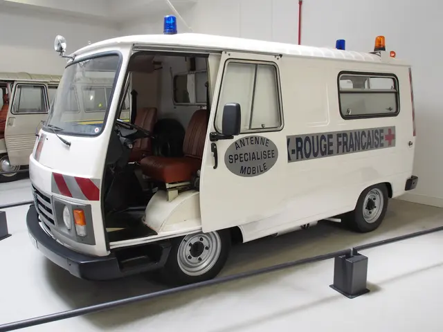 The image shows a white van parked inside of a building, with a wall in the background and a...