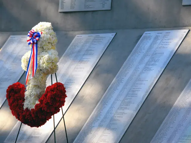 The image shows a wreath of red, white and blue flowers placed on the wall of the Vietnam Veterans...