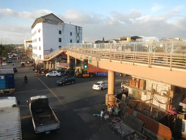 The image shows a bustling city street filled with lots of traffic, including cars, trucks, and...