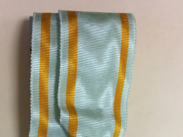 The image shows a medal with a blue and yellow ribbon attached to it, which is the Order of the...