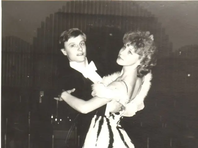 The image shows an old black and white photo of a man and woman dancing a waltz. The man is wearing...