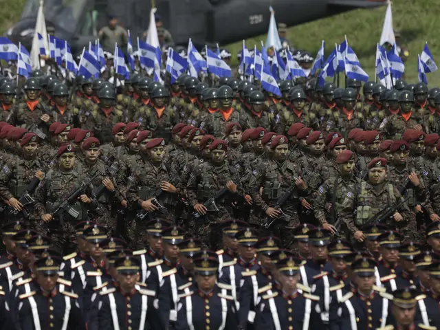 The image shows a large group of soldiers marching down a street, wearing caps and holding guns,...