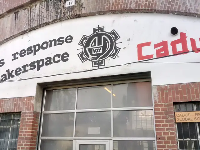 The image shows a building with glass windows and a door, with a sign on the side that reads...