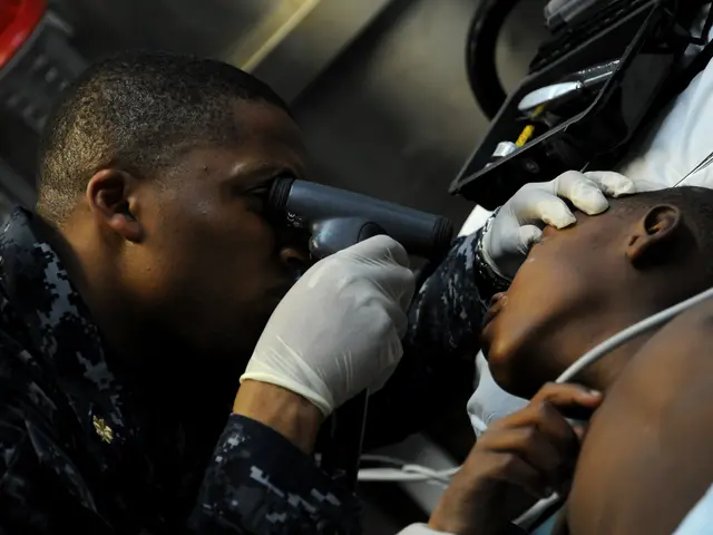 The image shows a man in a military uniform getting his eyes examined by a doctor. The doctor is...