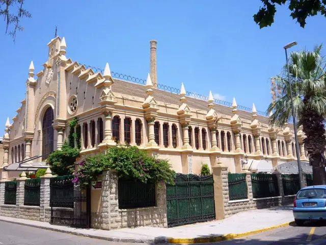 The image shows a large building with a car parked in front of it, surrounded by a metal fence, a...