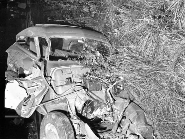 The image shows a black and white photo of a car that has been involved in a crash on the side of...