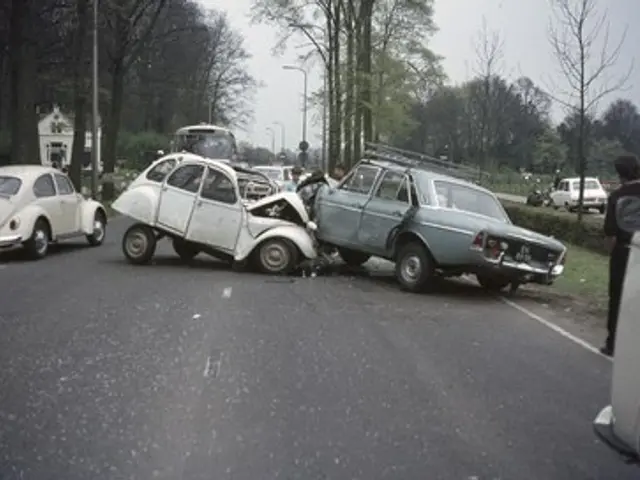 The image shows two cars that have been involved in a car accident on the side of the road. There...