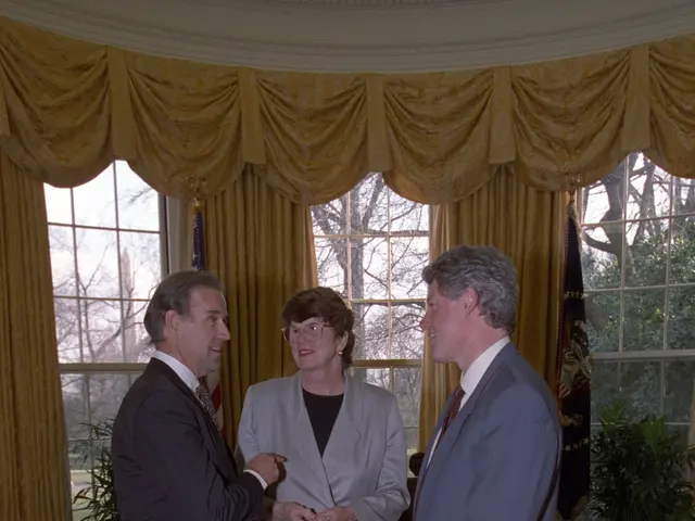 The image shows two men and a woman standing in the Oval Room of the White House, shaking hands....