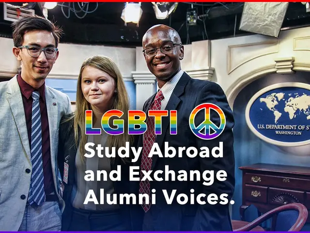 The image shows three people standing and smiling, two men and a woman, with a cupboard and chair...