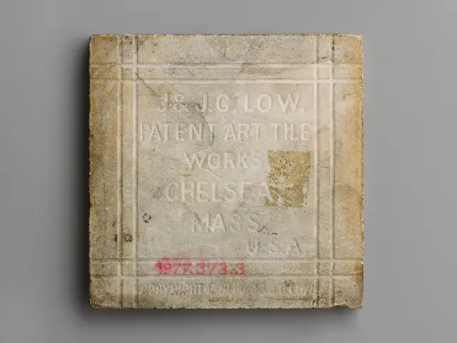 The image shows a stone tile with the words "J&G Low Patent Art Tile Works Chelsea, Massachusetts"...